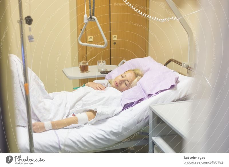 Bedridden female patient recovering after surgery in hospital care. bed sick woman healthcare medical medicine ill room recovery illness ward bedridden