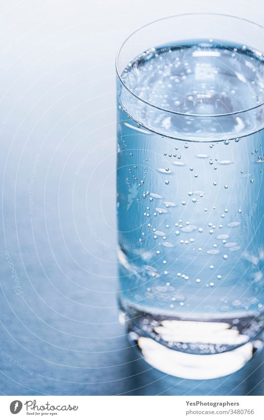 Glass of tonic water on blue background. beverage bubbles classic cold drink cold water cool diet drinking glass drinks fizzy fluid fresh full glass of water