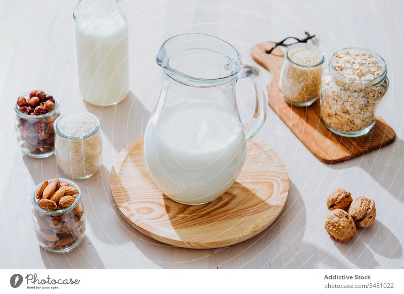 Ingredients for preparing vegan milk on table healthy natural alternative jar ingredient nut food diet oat almond rice hazelnut walnut oatmeal nutrition glass