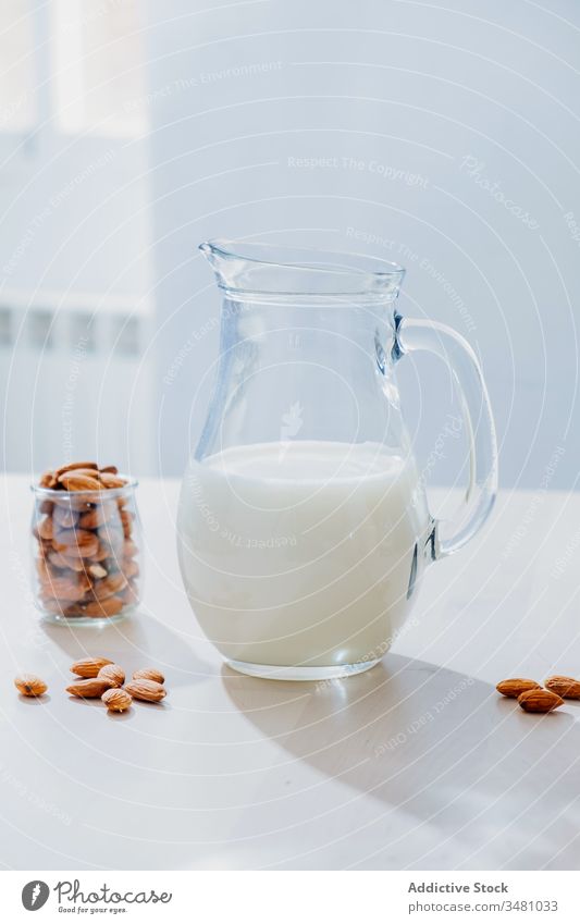 Jar of milk and almonds on table oat oatmeal jar vegan healthy natural nutrition food glass diet organic breakfast vegetarian drink ingredient morning cereal