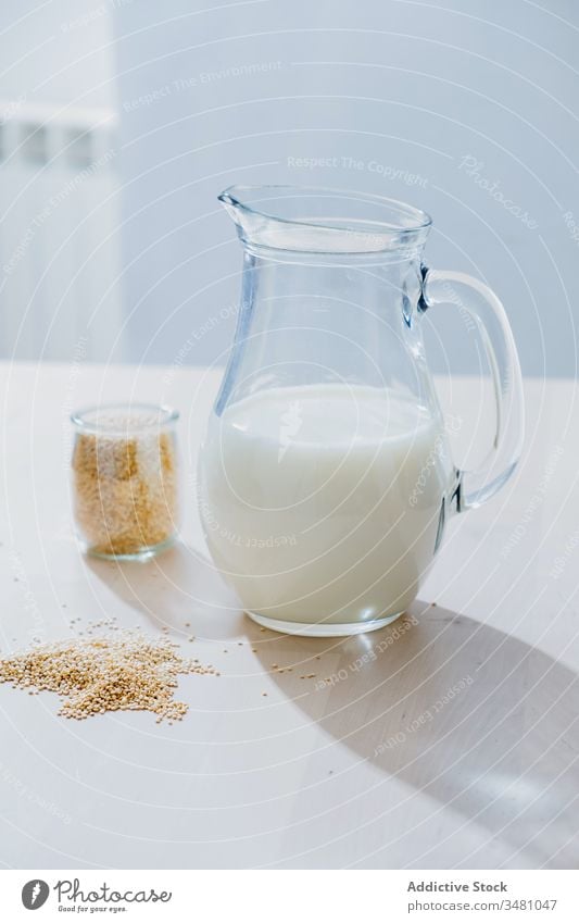 Jar of milk and oatmeal on table jar vegan healthy natural nutrition food glass diet organic breakfast vegetarian drink ingredient morning cereal beverage dairy