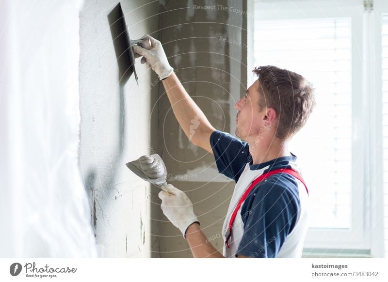 Plasterer renovating indoor walls and ceilings. construction plastering renovation worker craftsman plasterer occupation equipment repair professional building