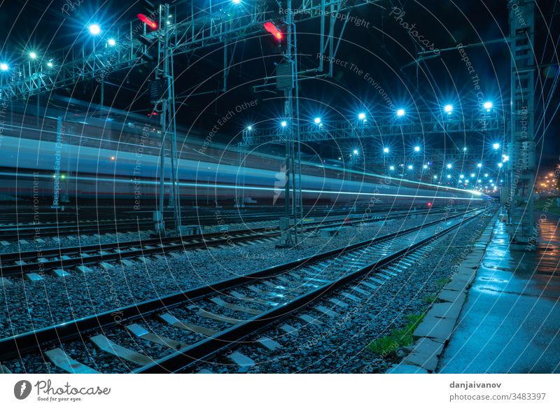 Long-exposure photograph night rail way .Moscow train railway city traffic railroad light transportation speed track travel station street highway rails urban