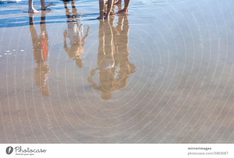 young bathers in bathing suits reflection on freshly wet sand joy leisure teen celebration fun beauty holidays vacations shoreline peaceful relaxation lifestyle