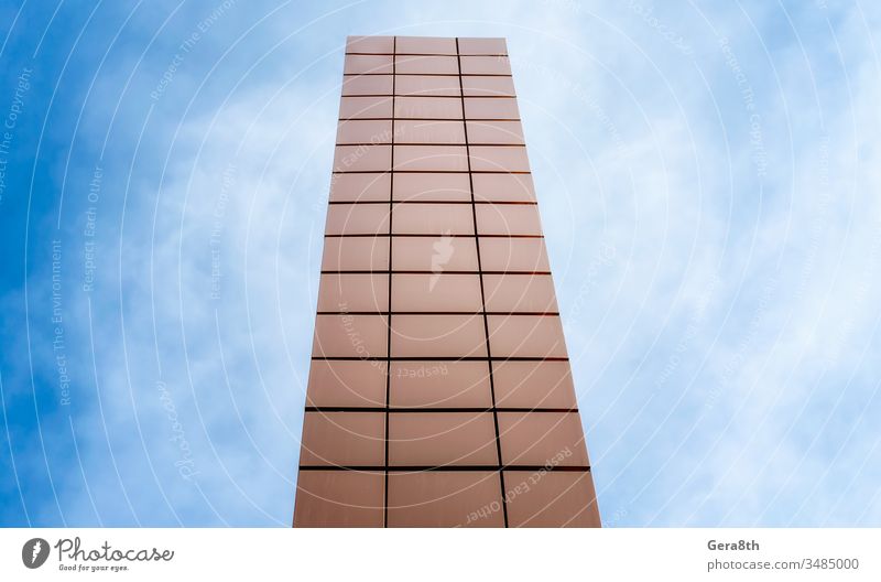 high tower on a background of blue sky and clouds abstract architecture block building city color geometry line modern orange perspective rise shape skyscraper