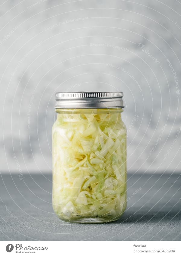 Sauerkraut in open glass jar, copy space sauerkraut cabbage fermented food dish raw barrel sour cumin salad stewed background white homemade pickled coleslaw