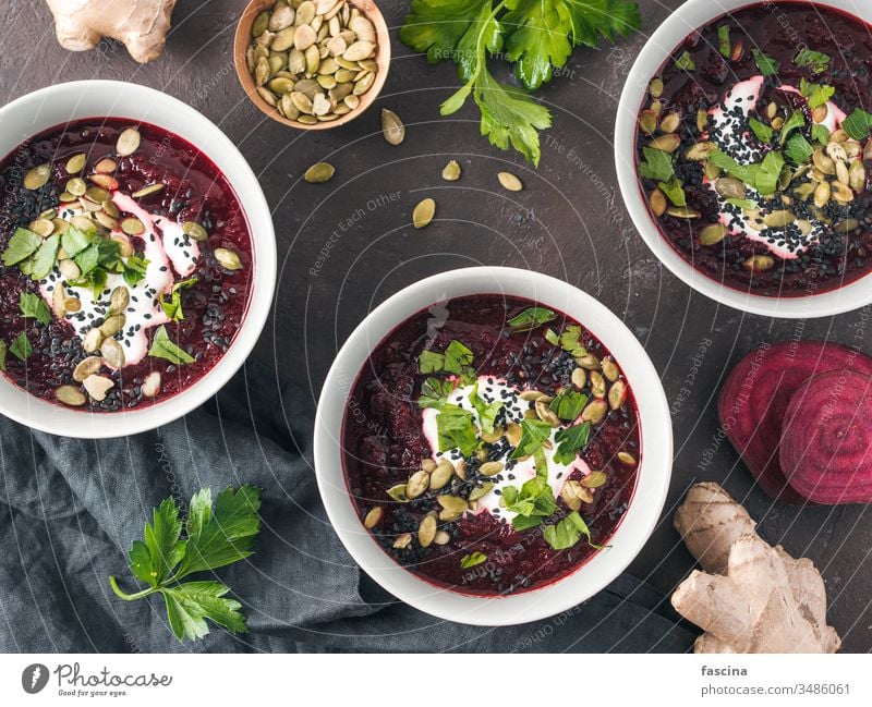 Beetroot ginger soup puree, top view beetroot smoothie raw food diet organic clean eating vegetable detox juice healthy pumpkin seed black sesame natural