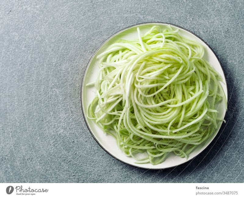 Zucchini noodles on plate. Top view, copy space zucchini zoodles spaghetti diet food fresh healthy lunch preparation raw vegan vegetarian green pasta squash