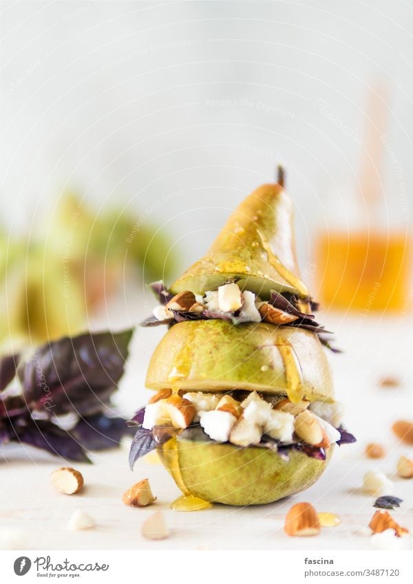 Pear and cheese salad with basil, nuts, honey cheese dairy pear idea recipe concept creative homemade almond goat cheese ready-to-eat breakfast meal dish dinner