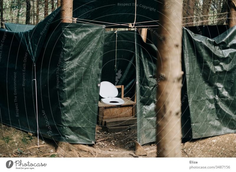 An outdoor toilet with tarpaulin protected outside in the forest; camping, holiday camp, outhouse, toilet Toilet john Latrine Forest Camping Deserted