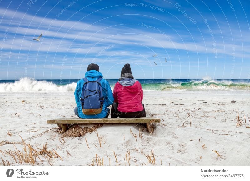 Dreamy couple looking at the waves on the beach of the Baltic Sea Ocean Beach Woman Man North Sea Sit Break Hiking free time Couple Family together beach hike