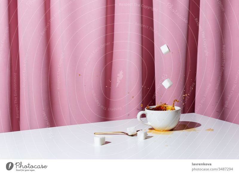 Cup of tea or coffee on white table in front of pink drapery, selective focus caffeine black espresso aroma morning beverage cup curtain drink hand holding hot