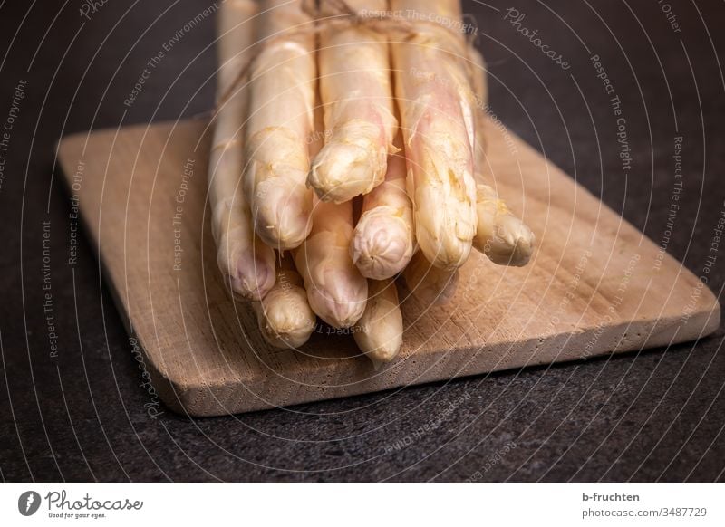 A bunch of white asparagus on a chopping board kitchen board Asparagus Vegetable Food Nutrition Vegetarian diet Healthy Eating Fresh Asparagus season Close-up