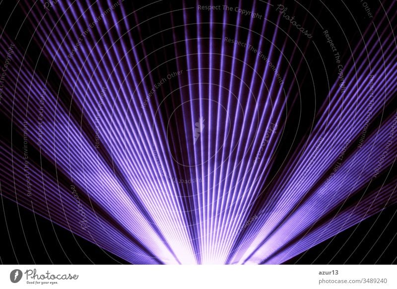 Purple laser show nightlife club stage shining sparkling rays. Luxury entertainment in nightclub event, festival, concert or New Years Eve. Ray beams are symbol for science and universe research