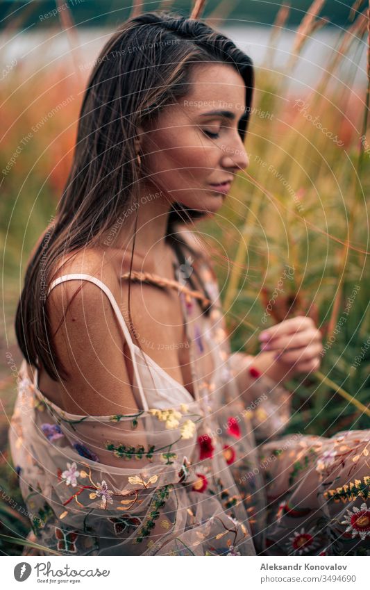 Young woman in transparent dress with flowers sit on a grass with wheat ear in her hand. Youth (Young adults) romantic romantic mood fresh knee Dress