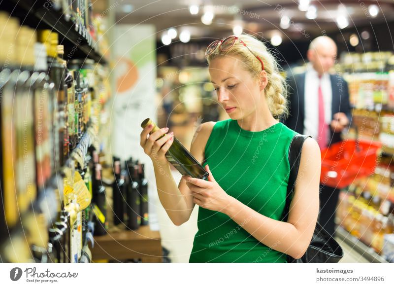 Woman shopping groceries at supermarket. grocery store customer consumer basket food people young person buy woman commerce adult lifestyle aisle girl business