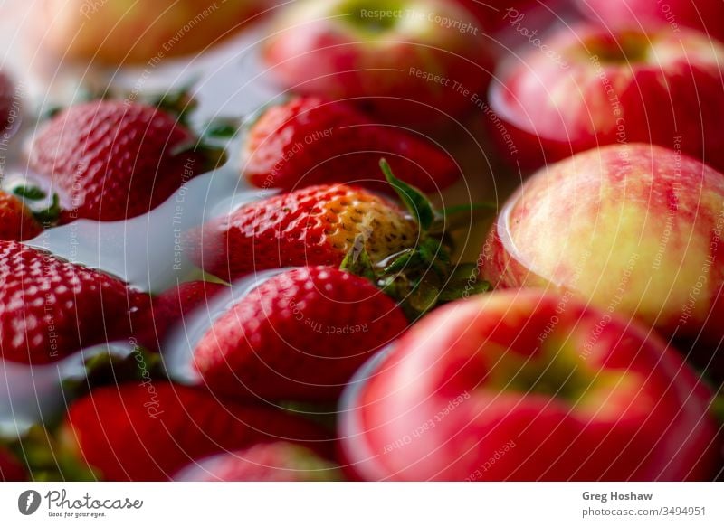 Close-Up of Fresh Organic Strawberries and Apples Floating in Water Strawberry organic fruit Organic produce Colour photo Vegetable healthy vegan