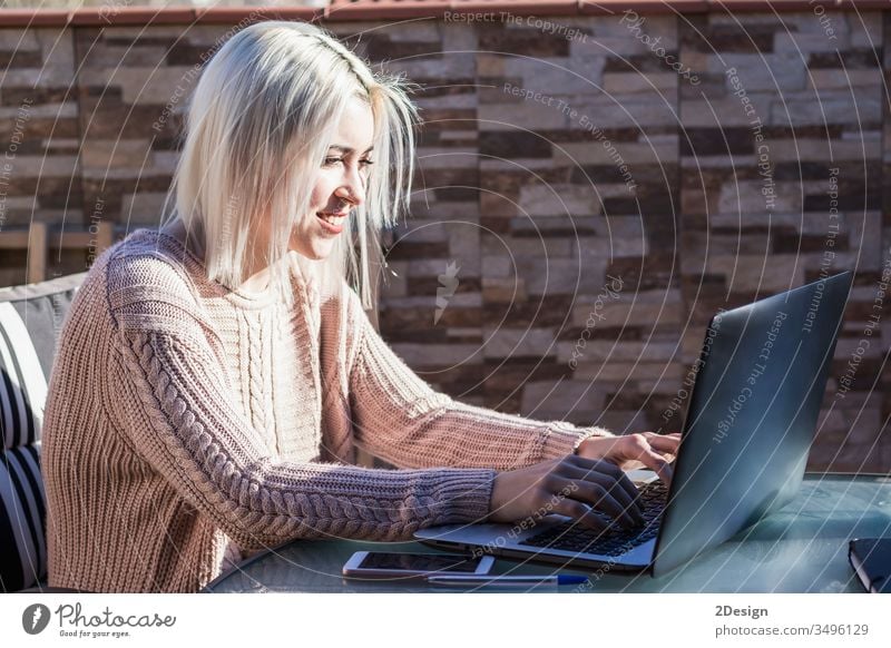 Student woman using laptop while sitting outdoors at home terrace. female young girl computer happy people person lifestyle student cyberspace business online