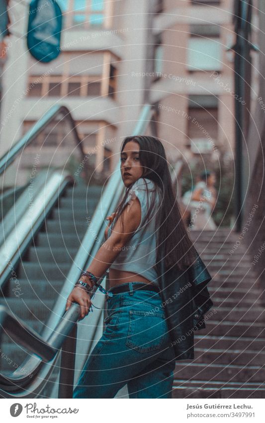 young model in blue jeans and a black leather jacket Style Woman Colour photo Beautiful Young woman Paint Human being Portrait photograph Fantasy Mystery light