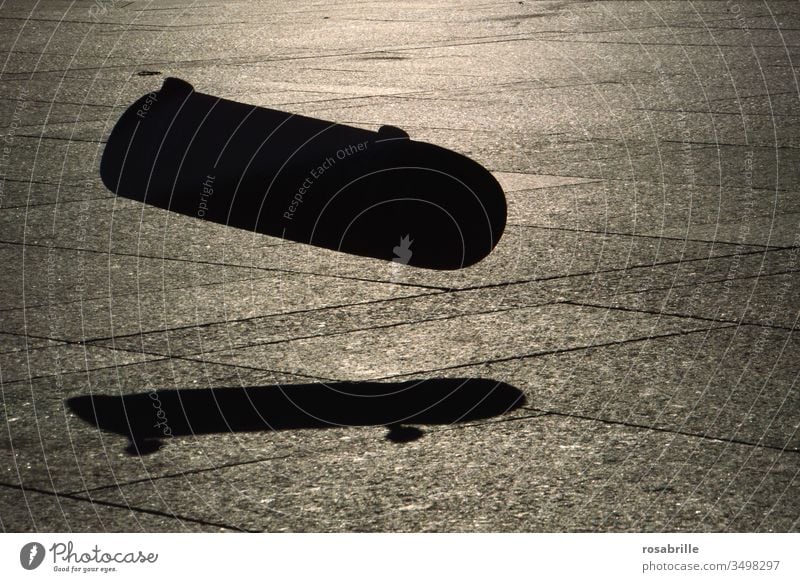 he jumped | close to it | and his skateboard flew on without him Skateboard Shadow Jump Skateboard Jump close missed Sunlight evening light Light Silhouette