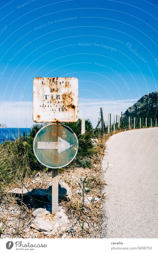 Old road sign on a coastal road Coastal road Mediterranean sea Ocean Curve Right Arrow Along here Exterior shot Colour photo Deserted Transport