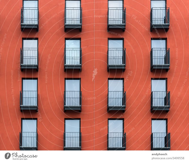 Front of a new red residential house with black balconies apartment architecture Background balcony Berlin building building exterior cable city construction