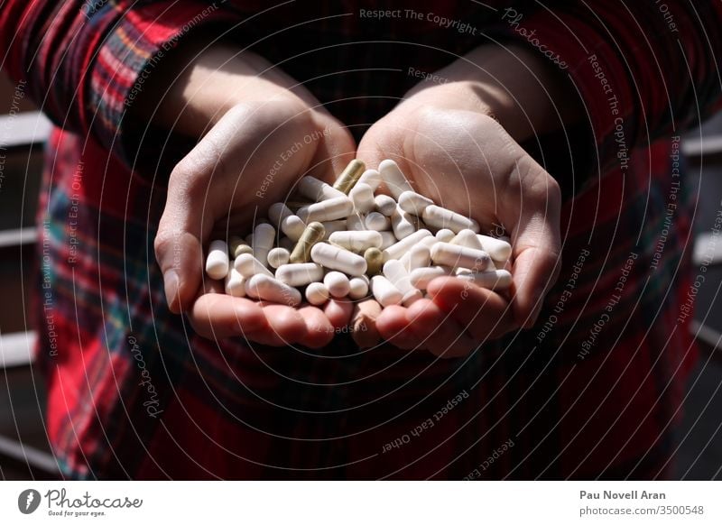 Woman holding pills on hand. Medicine and health care concept. Woman taking medicine. Healthy lifestyle, nutritional supplements many painkiller capsules