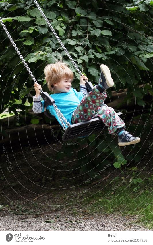 Child has fun on the swing | Favourite person youthful Human being Toddler Swing Joy To swing game Movement Playground Laughter Playing Infancy Colour photo