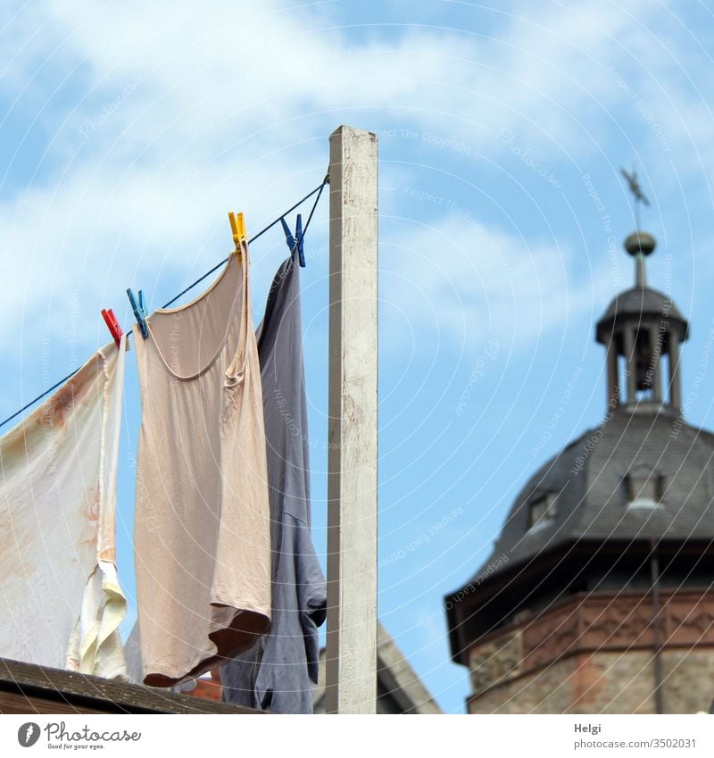 Washing day - laundry hangs to dry on a clothesline, near a church tower Laundry Clothesline staples Clean Dry Clothes peg Colour photo Clothing Hang up