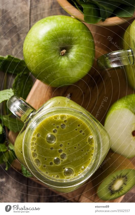 Healthy green smoothie in jar on wooden table apple detox diet drink food fresh fruit ginger glass healthy healthy drink kiwi mint nutrition shake spinach