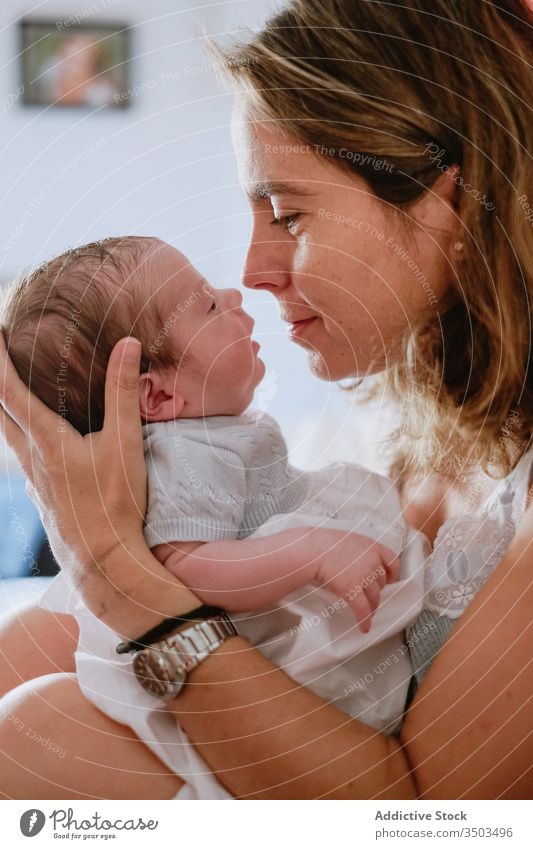 Happy mother holding newborn child happy woman baby care together love motherhood smile kid parent adorable childhood innocent infant little cute comfort