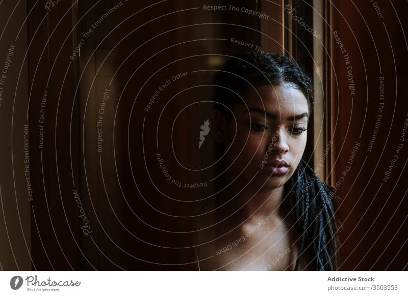 Relaxed woman sitting on balcony at home calm dream casual tranquil thoughtful relax young african american black ethnic female house city apartment building