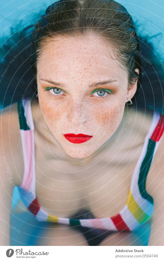 close-up of a brunette girl with long hair on a stairs in the pool water blue leisure teenager young female woman person summer fun people beautiful swim wet