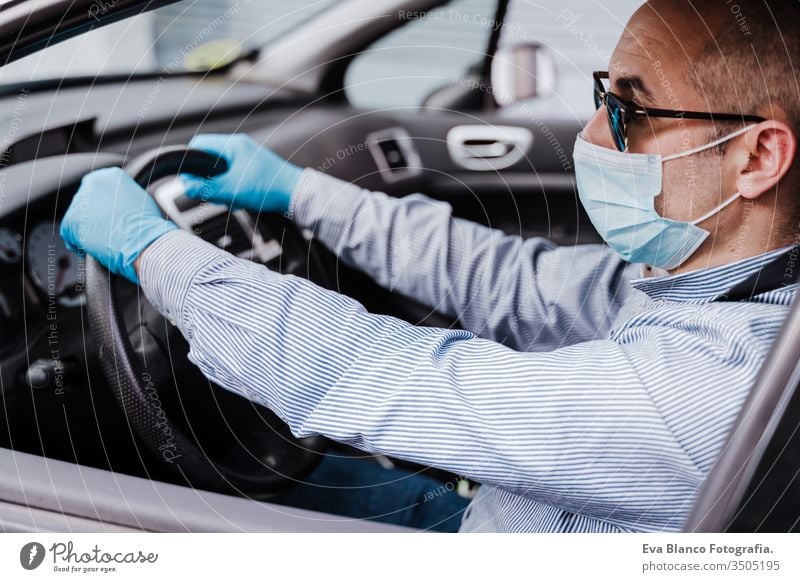 man driving a car wearing protective mask and gloves during pandemic coronacirus covid-19 coronavirus protective gloves infect automobile health transport air