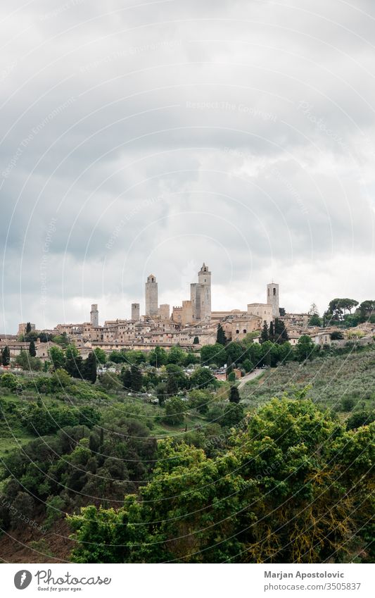 Stormy weather over high towers of San Gimignano, Tuscany, Italy ancient architecture attraction building castle cathedral church city cityscape clouds cloudy