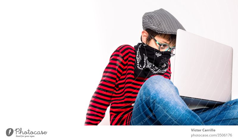 Cute boy with glasses on a white background with a mask using a laptop indoors adorable beautiful casual cheerful childhood color computer confident cool copy