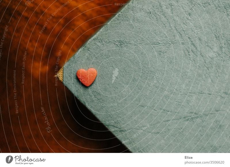 A red heart lying on a blue background Heart Red Love Relationship Mother's Day In love Romance Infatuation Deserted Emotions Valentine's Day Interior shot