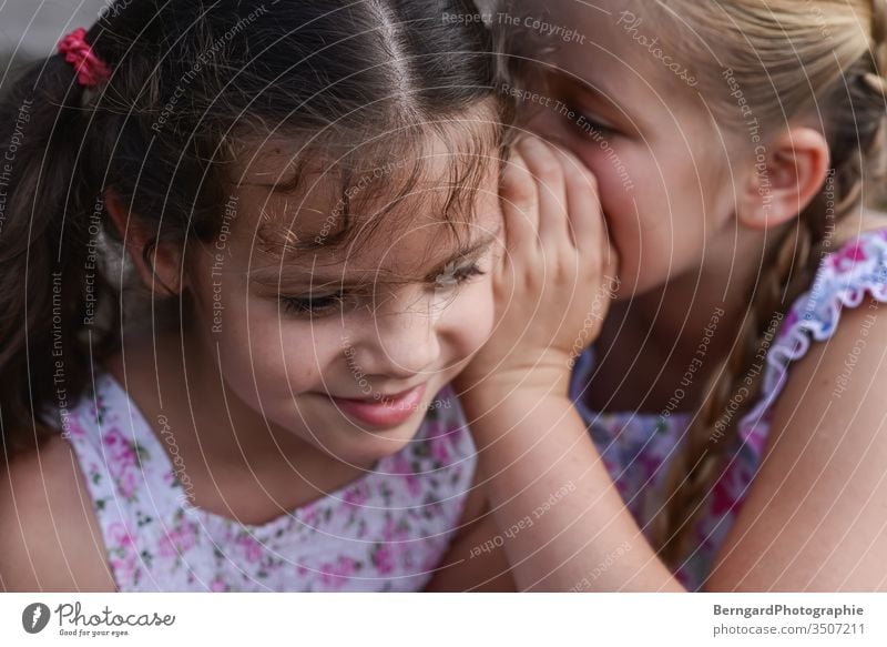 Two sisters play games mystery Mysterious Smiley happy Sister Friends Summer Dress children girls playtime