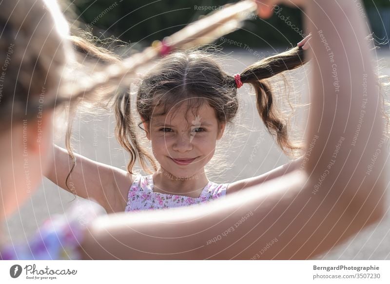 Two sisters play games Child gilr Summer Sun hair Smiley happy