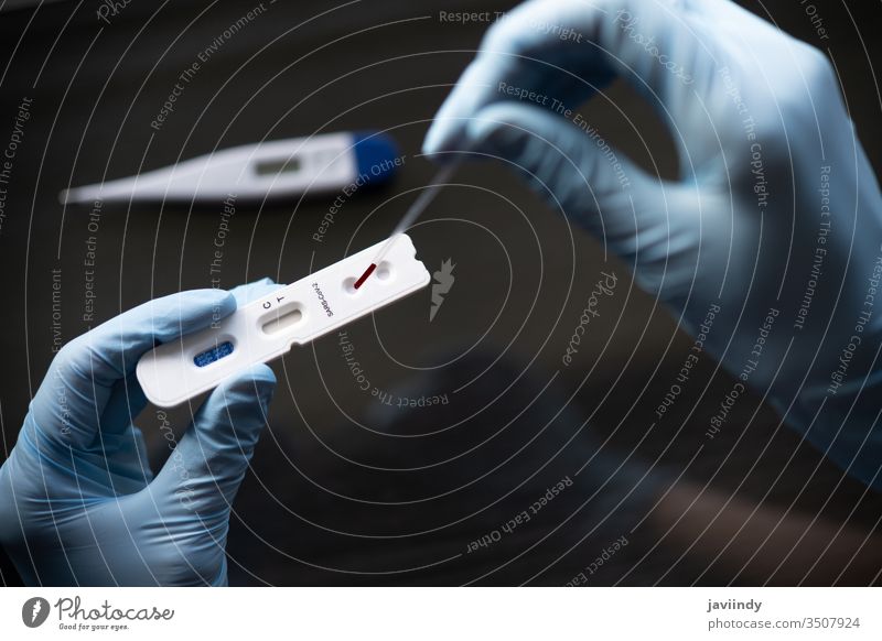 Doctor testing using the rapid test device for COVID-19 covid-19 coronavirus sars patient tested research pneumonia flu epidemic disease laboratory sick