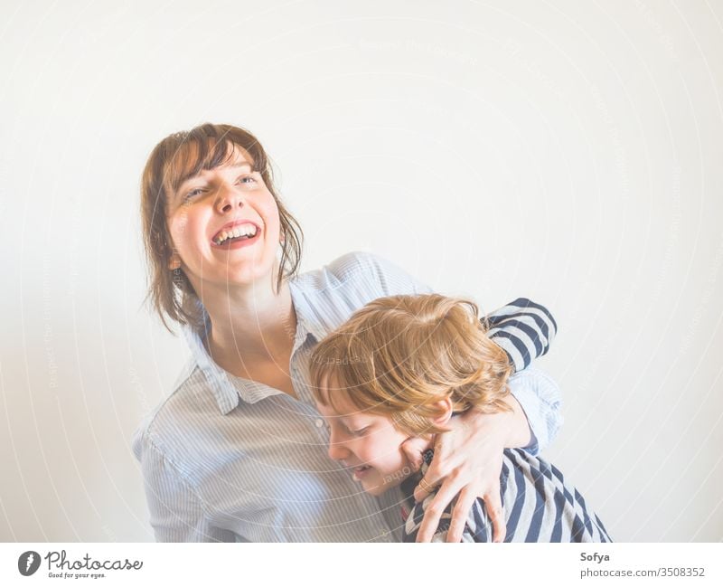 Young mother and child hugging. Mothers day mom parent mothers day woman lifestyle kid love son together family emotion feelings face eyes caucasian happy