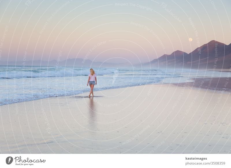 Lady walking on sandy beach in sunset. woman sea landscape coastline footprint footstep vacation water nature summer female waves beautiful ocean barefoot