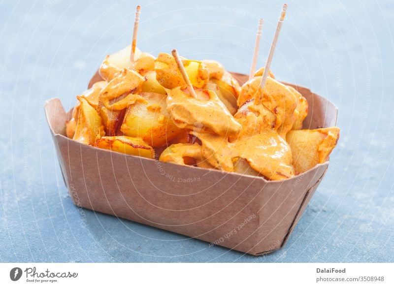 Patatas bravas traditional Spanish take away background baked bar chips closeup cuisine dish food fried garlic home horizontal ketchup mayonnaise mediterranean