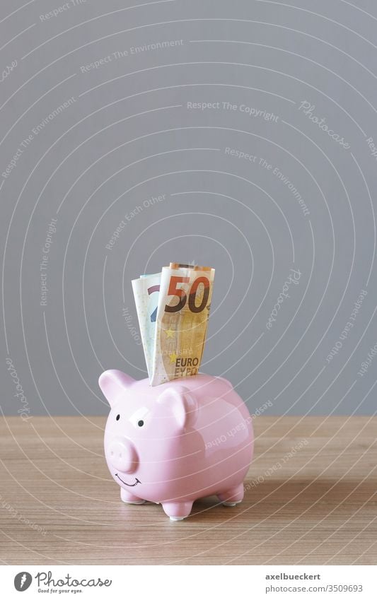 piggy bank or piggybank filled with euro bills saving money banknotes money box save cash finance business wealth banking pink financial savings economy paper