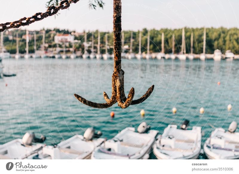 Rusty anchor with a harbour background anchored boat cargo closeup coast coastal concept design detail dock docked equipment fisherman fiskardo front greece