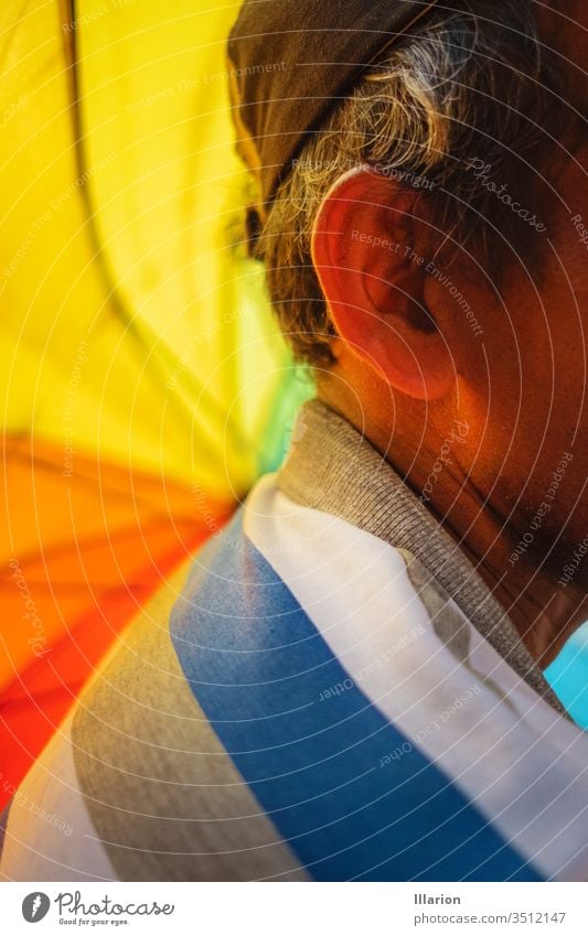 Close up of an old man`s ear with a rainbow umbrella on the foreground Elder Ear Rainbow rainbow colored Rainbow cloth Colour colors colorful Multicoloured