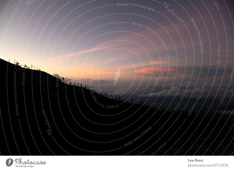 I've been hiking to the famous Blue Fire of Ijen, an active Vulcan on east Java and stayed there for sunrise. sky clouds nature landscape orange mountain dusk