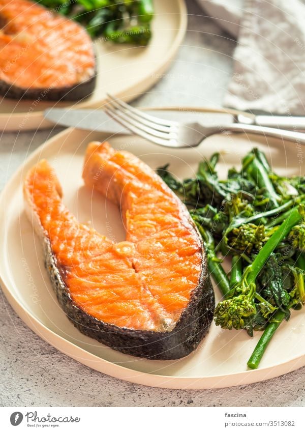 Ready-to-eat grilled salmon steak and greens baby broccoli broccolini spinach plate keto diet healthy food brain throught fish omega3 omega6 fat fatty good