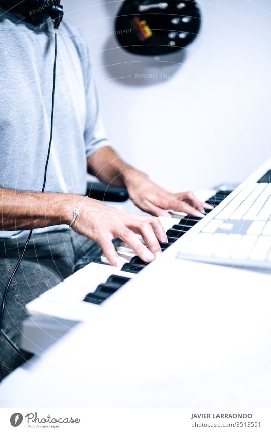 Musician playing piano desk midi artist audio equipment digital composer entertainment computer headphone instrument keyboard listening live music backgrounds