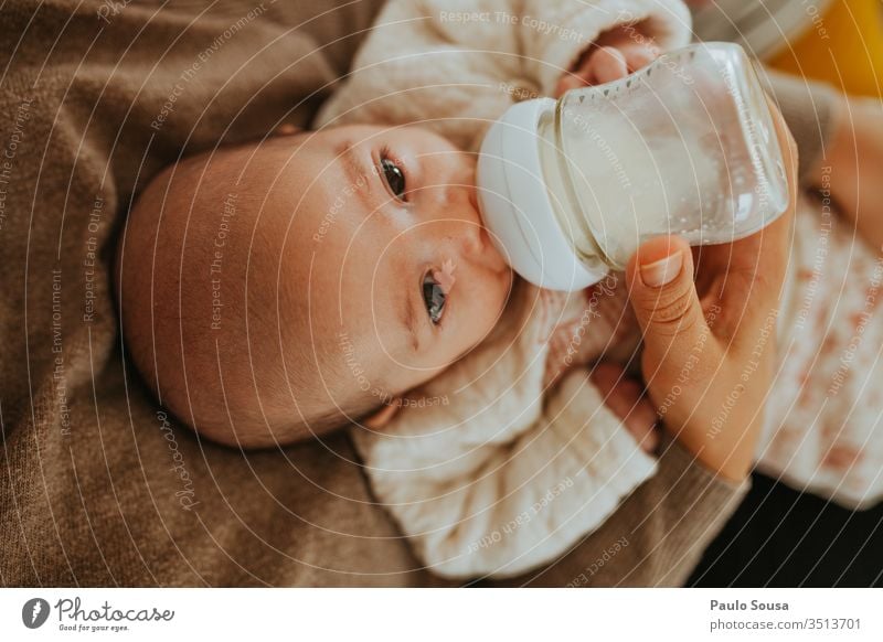 Mother bottle feeding baby Bottle Baby bottle Neck of a bottle Colour photo Interior shot Glassbottle Together togetherness motherhood Mother with child